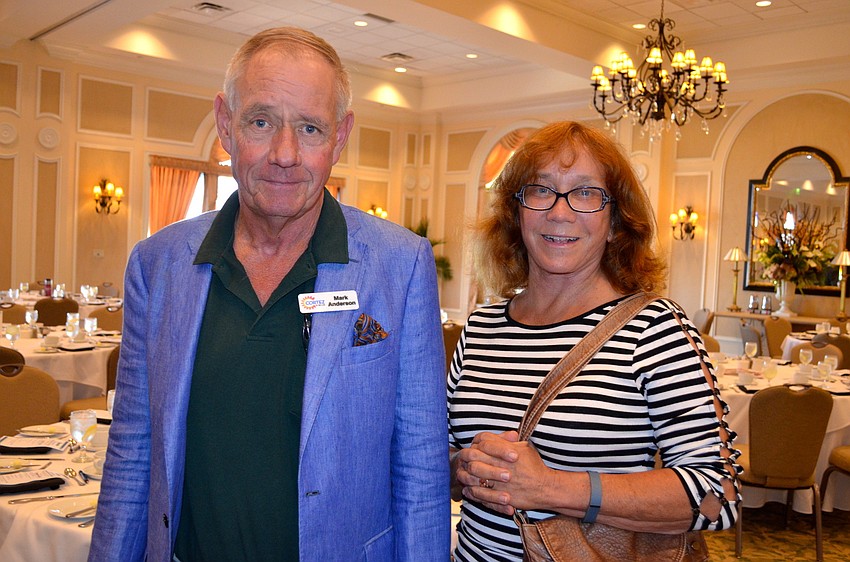 Mark Anderson and Marcia Watson find their seats before lunch is served.