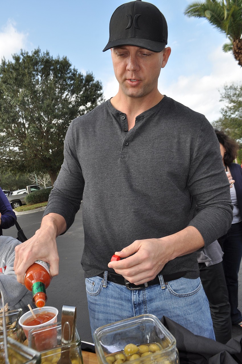 Steve Ekes adds an olive and Tobasco to his bloody mary.