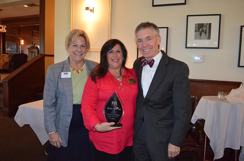 2014 Chairman of the Board Yvonne Schloss, with President Gail Loefgren and board member Matt Walsh, accepts the Chamber Member of the Year award.