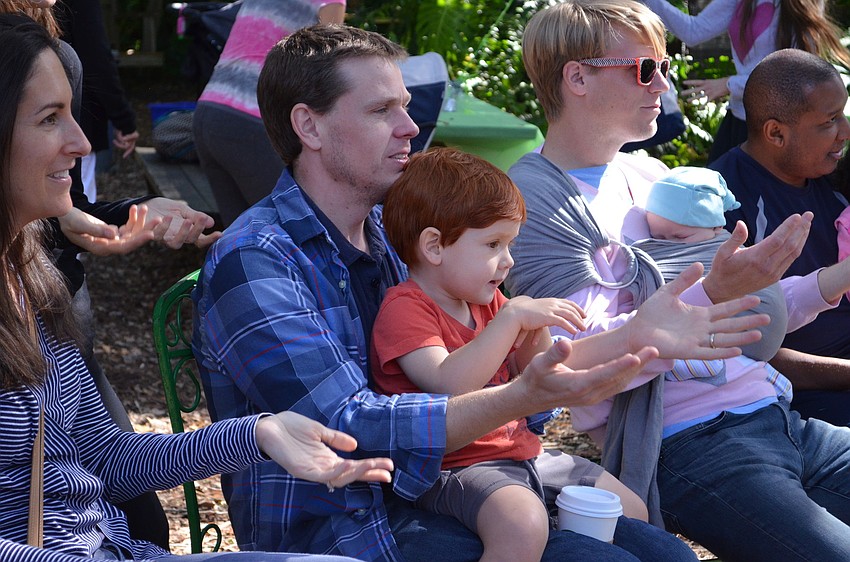 John Bryant and his son Woody sing along during the Birthday of the Trees service.