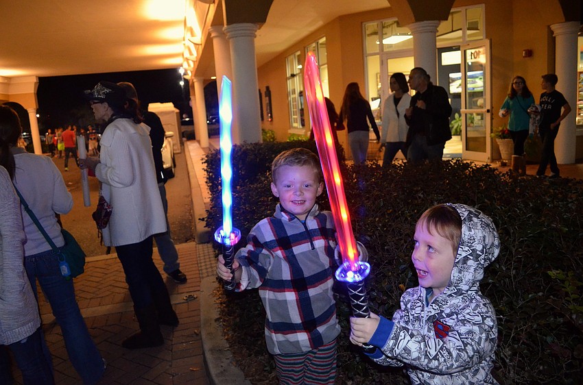 Graham Durick and Kellan Jones battle with their light-up swords.
