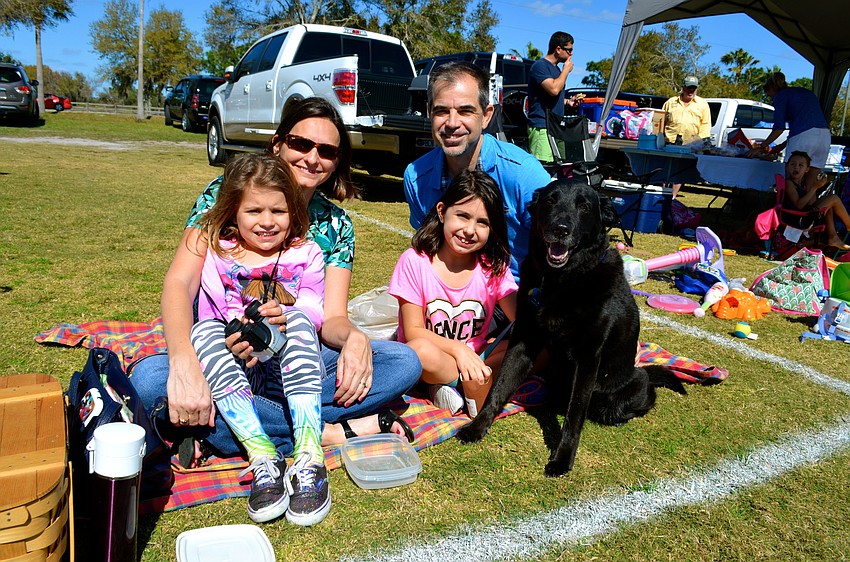 The Johnson family â€” Siena, Angie, Violet and Michael â€” enjoy a family day out with their dog, Maggie.