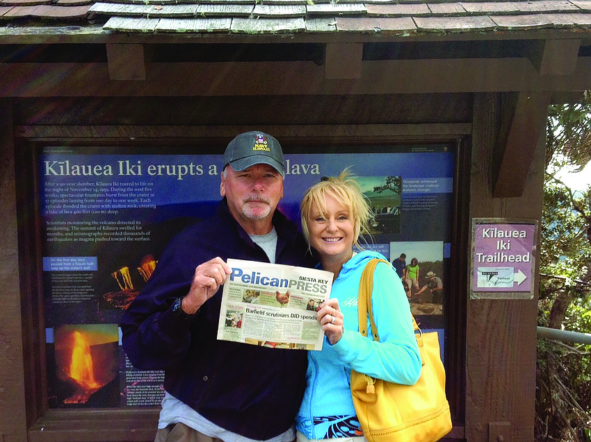 ACTIVE VACATION. Jack and Karen Terry catch up on their Pelican Press news while standing on Mauna Loa, the largest active volcano in the world. The couple traveled to Hawaii to visit their daughter, Hayley, who is a traveling nurse.