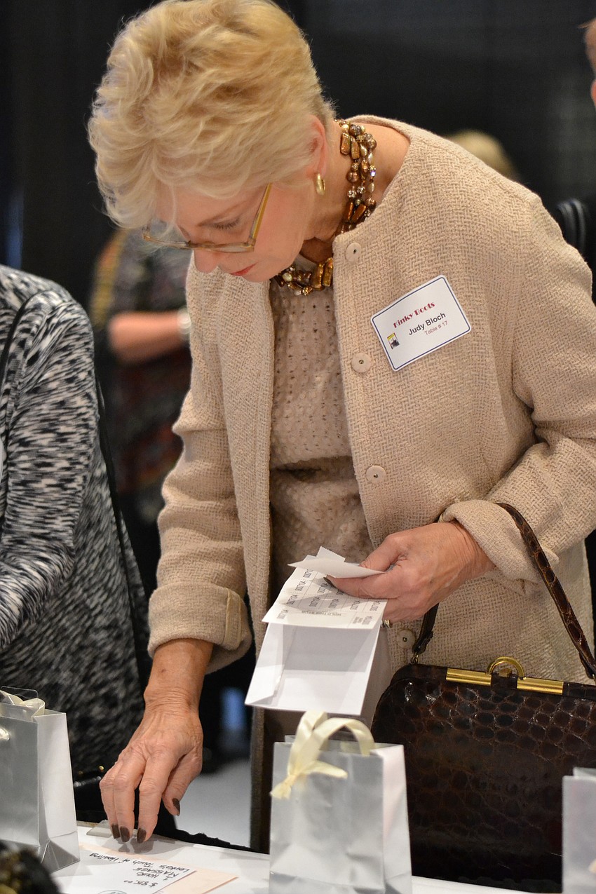 Judy Bloch places a bid for the silent auction.