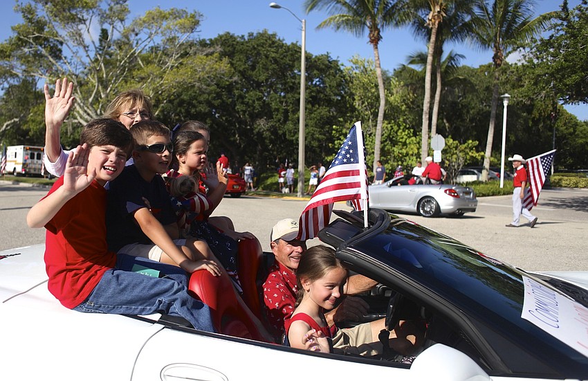 Commissioner Lynn Larson and her grandchildren wave during the parade.