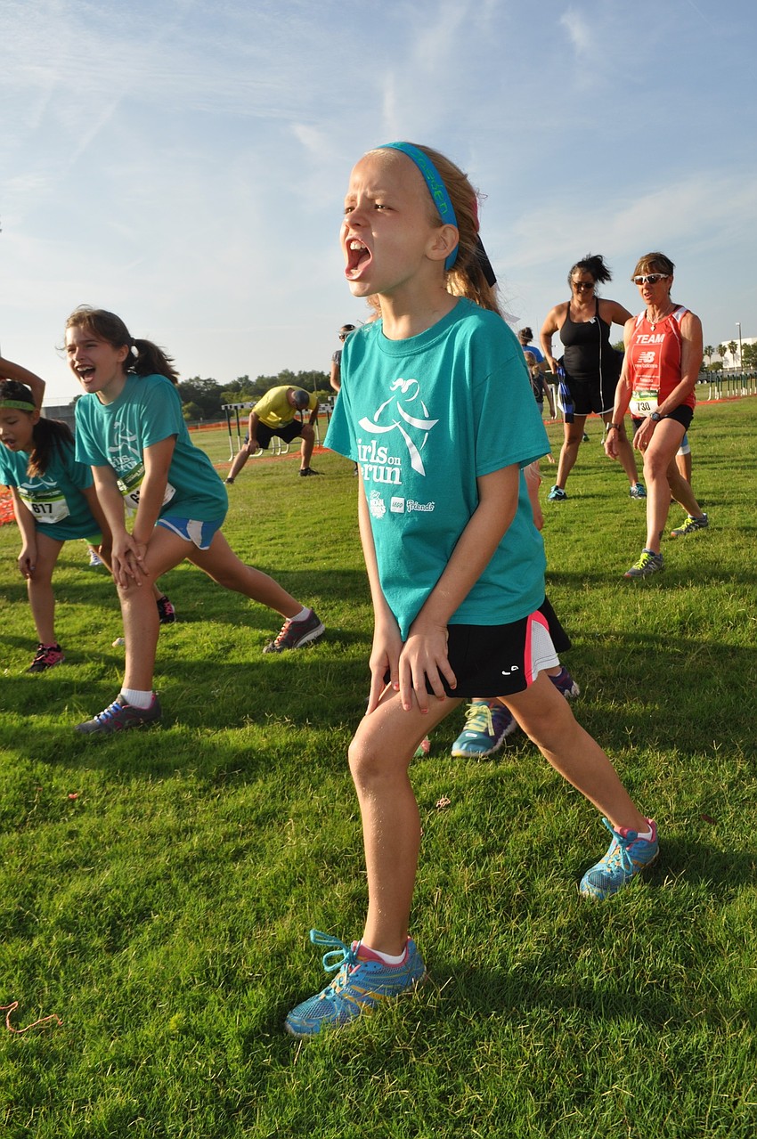 Girls Inc. participant Jaeden Rae stretches before the race.