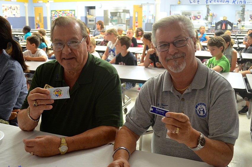 Chuck Stolteben and Rick Thorson show off their gifts from the school.