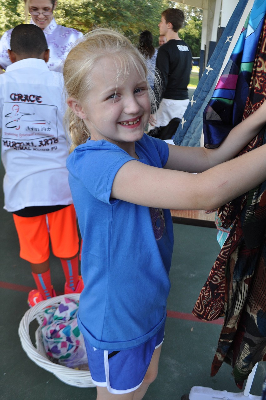 Hailey Williams, who turned 8 May 22, sorts through costumes.