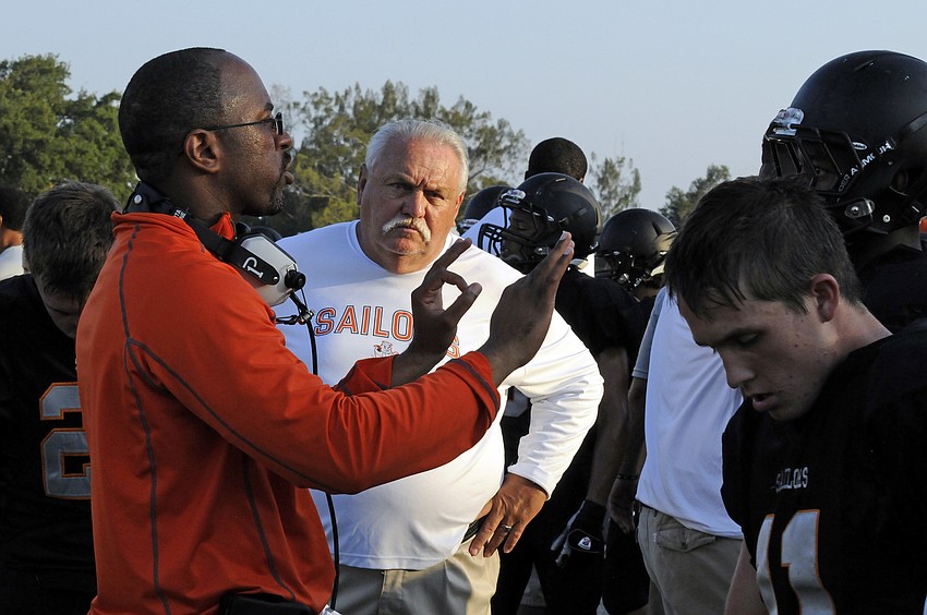 First-year head coach Brian Ryals talks to his offense on the sidelines in the second quarter.