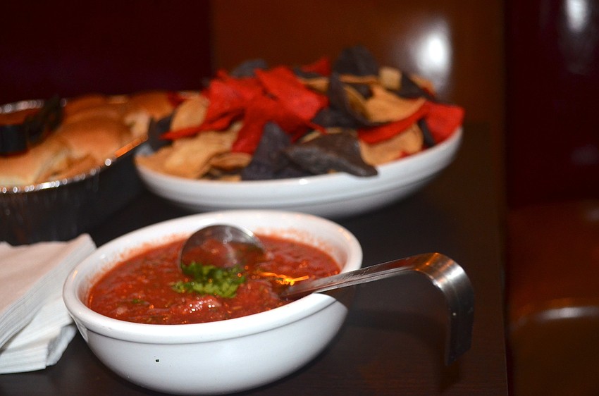 Attendees of the social snack on chips and salsa while mingling with other Alliance members.