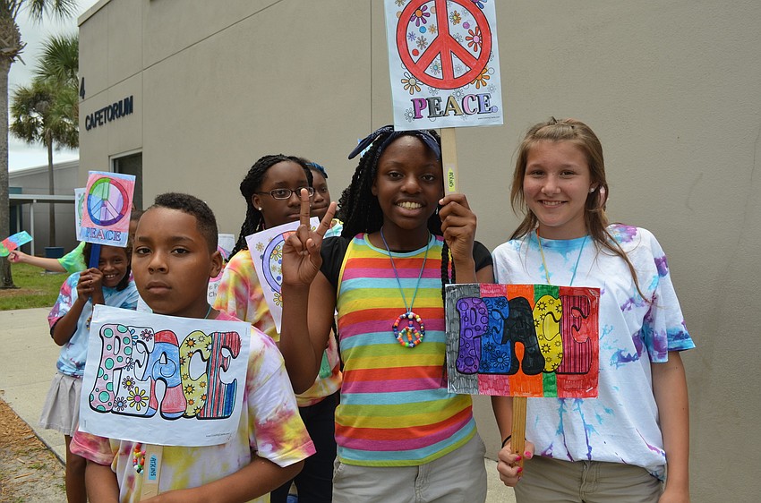 Glenntreal Collier, Chanel Mills and Heiden Riegel flash peace signs.