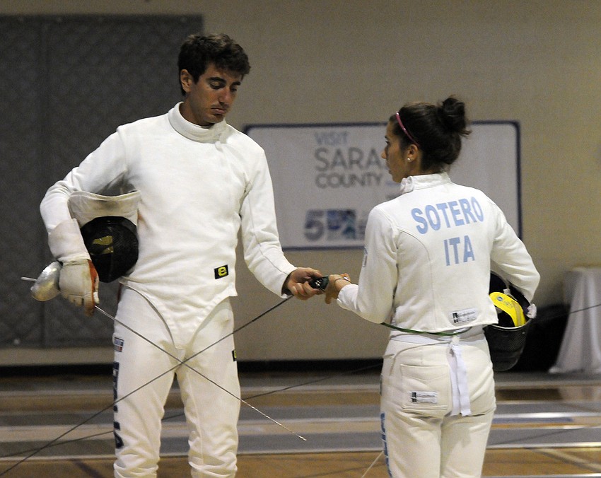 Italyâ€™s Riccardo De Luca and Alice Sotero strategize before the start of their next bout.