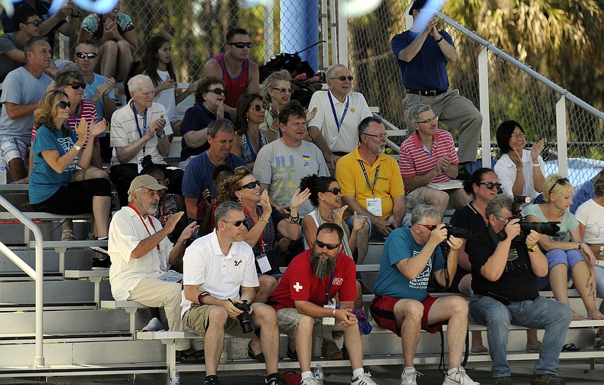 A couple dozen spectators, coaches and volunteers celebrate following the United Statesâ€™ first-place finish in heat 1 of the 200-meter freestyle mixed relay June 8.