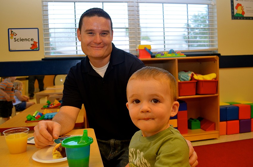 Greg Wright and his son, Sean, joke around during breakfast.