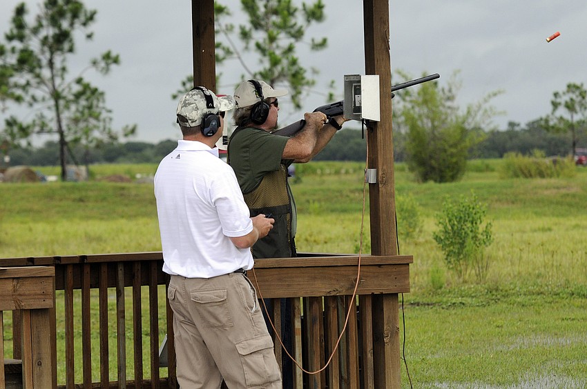 Liberty Ammunitionâ€™s Matthew Phillips controls the targets while Jim Edwards fires off a shot.