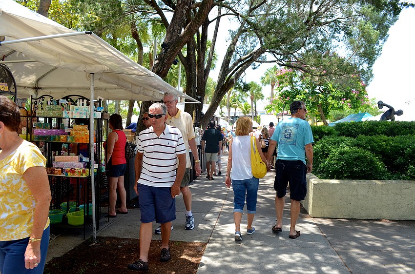 Festivalgoers walk from booth to booth and enjoy the wide variety of work featured at the festival.