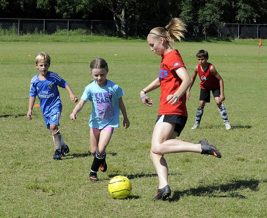 Lakewood Ranch Highâ€™s Danielle Wilson attempts to shoot the ball past Willis Elementary third-grader Aubrey Robbins.