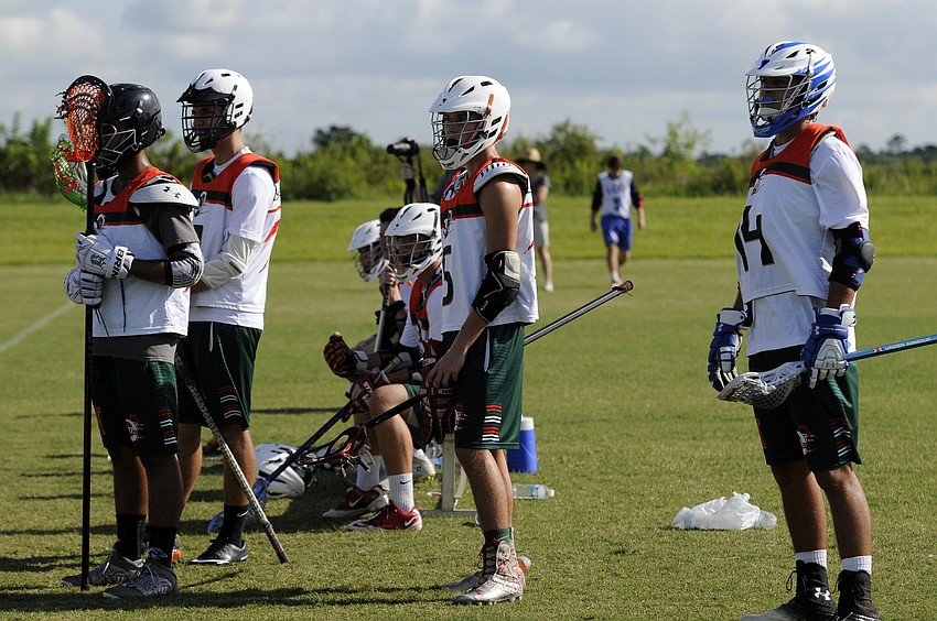 Members of the LB3 Monsters high school B team watch from the sidelines during their teamâ€™s 10-1 victory over Wellington Lacrosse Club June 21.