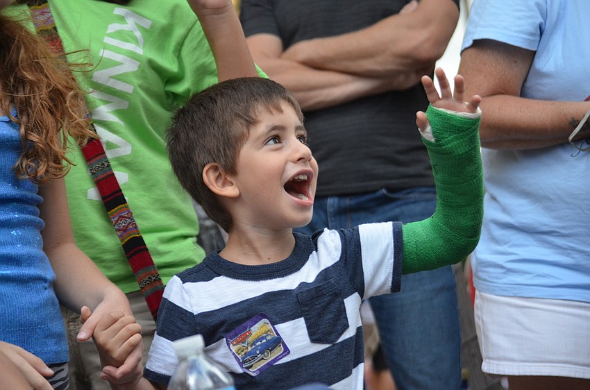 Aiden Duffy cheers on the boats.