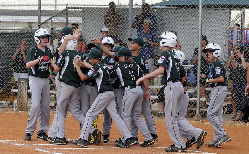 The Lakewood Ranch Little League Majors All-Stars celebrate following George Davisâ€™ two-run home run in the bottom of the first inning versus Buffalo Creek.