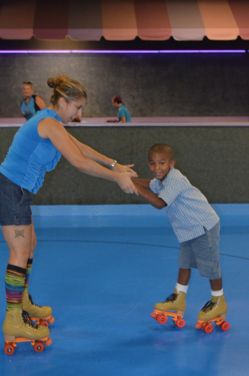 Dawn Eckert helps son, Devon Gordon, skate.