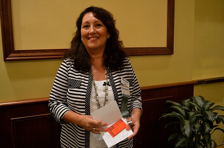 Yasemin Chain, of ComCenter, shows off her prize.