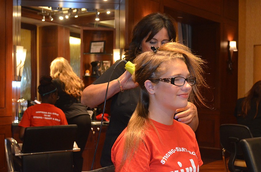 Rose Heiman has her hair curled by Corinne Medved.