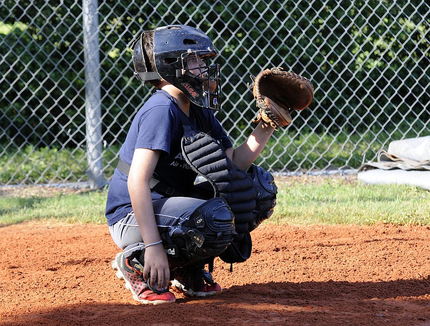 Eleven-year-old catcher Britton McClintock plays baseball for Braden River Little League.