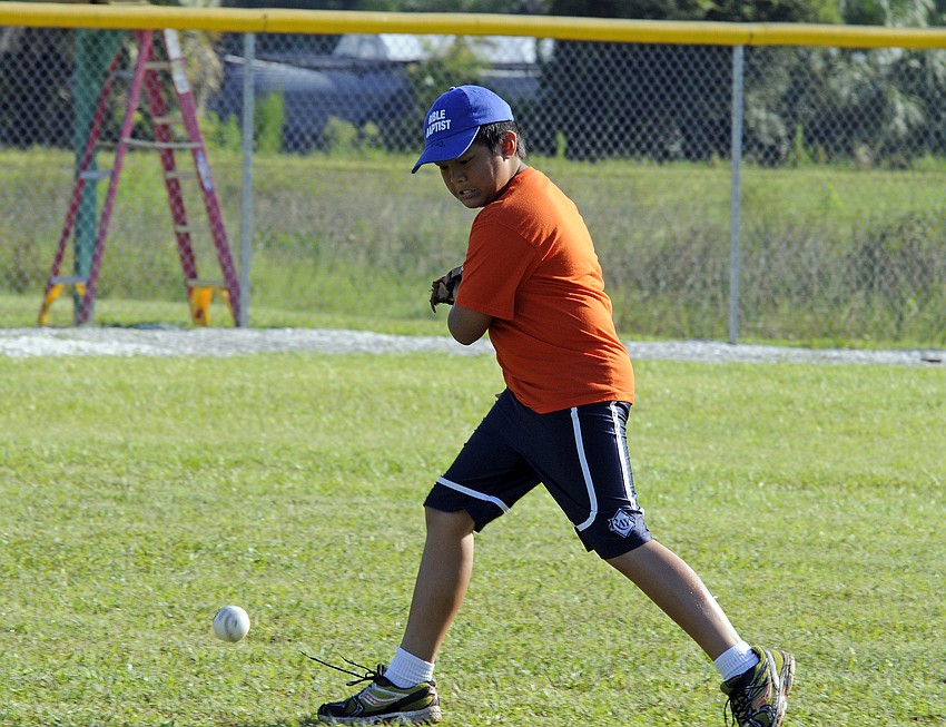 Ten-year-old Jared Relao works on his fielding before the game.
