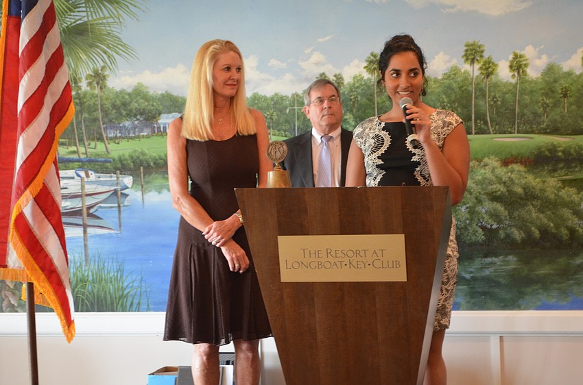 Olivia Doraisamy, State College of Florida, is awarded a technical scholarship by Scholarship Committee Chair Susan Philips and Longboat Kiwanis Club President Richard Crawford.