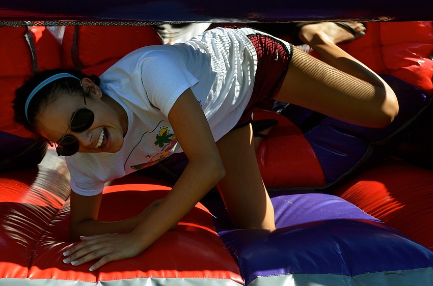 Camp volunteer Idallas Quintones races through the obstacle course.