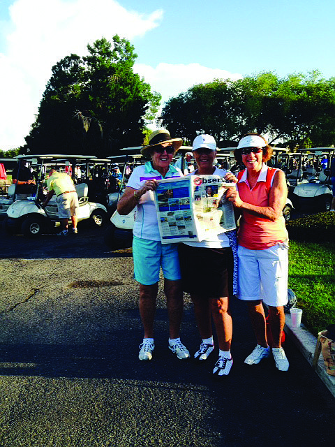 GOLF GALS. Longboat Key Public Tennis Center players Dolores Levy, Marsha Glawitsch and Francesca Harris read their Longboat Observer at the Rolling Green Golf Club in Sarasota.