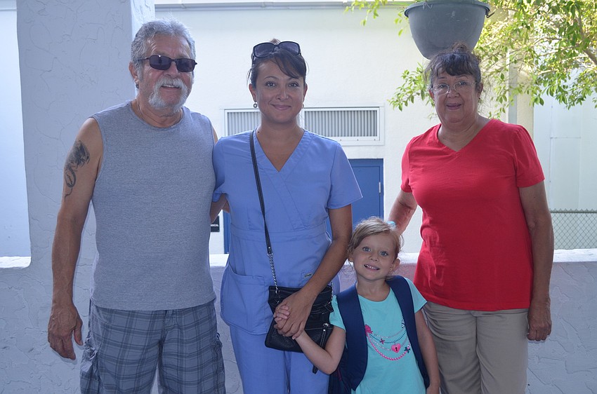 Francis Bersch (center) was dropped off by her mom, Farrah, and grandparents, Edgar and Maritza Gonzalez.