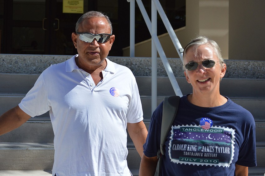 Jorge Reynardus and Patty Buttenheim leave Longboat's only Sarasota County polling place after casting their vote for the primary election Tuesday.
