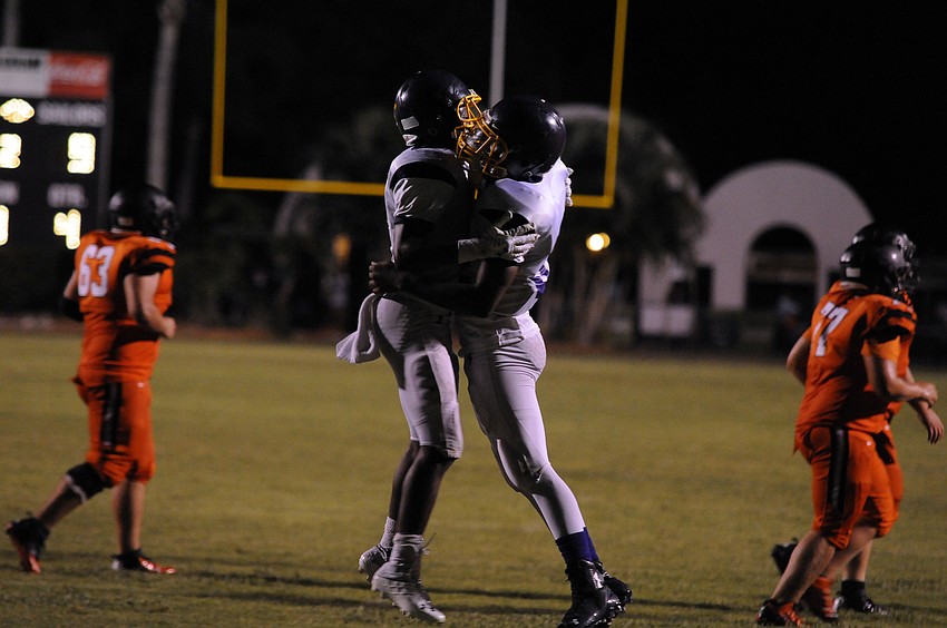 A pair of Booker defenders celebrate after forcing a fumble on fourth and goal to secure the victory for the Tornadoes.