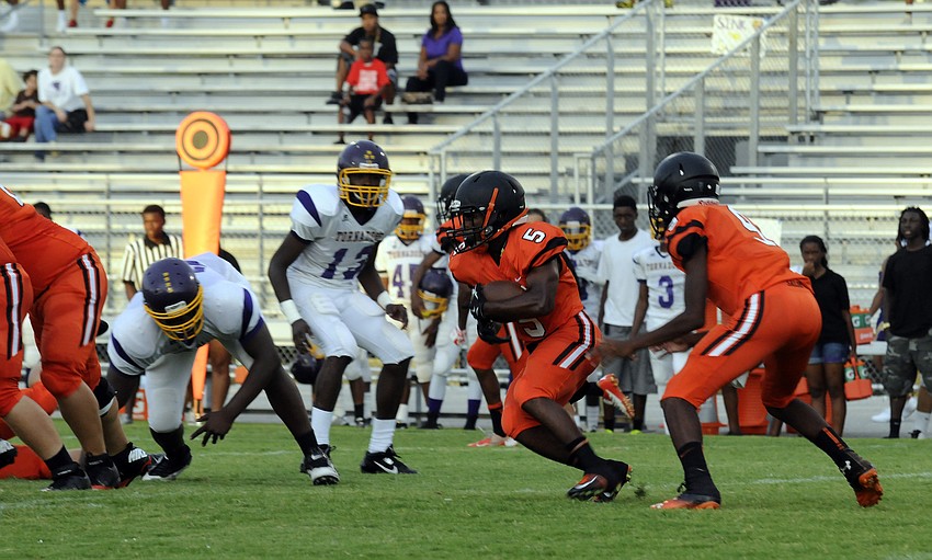Sarasota senior running back Justin Austin carries the ball for a short gain early in the first quarter.