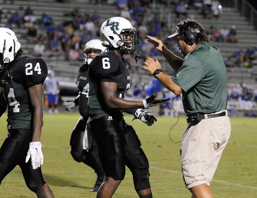 Lakewood Ranch head coach Mick Koczersut celebrates with Daymon Murray following the Mustangs touchdown in overtime.