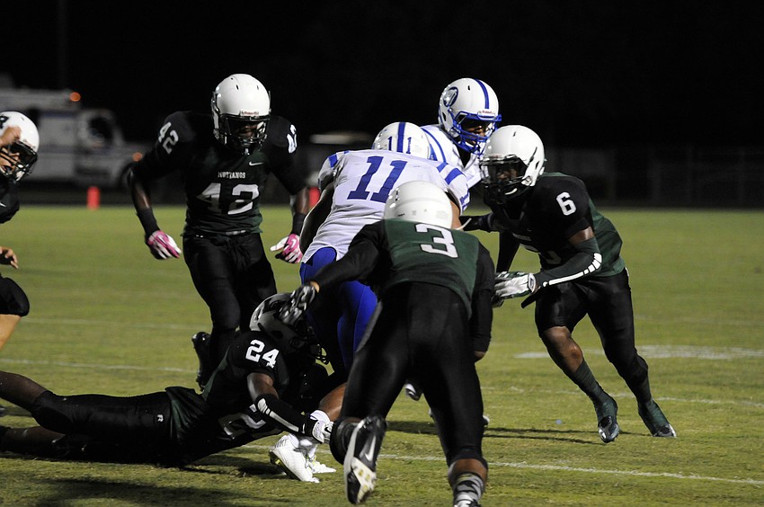 A host of Lakewood Ranch defenders wrap up Tampa Jesuit running back Kevin Newman.