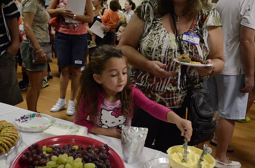 Ella Diamond, 6, and her grandmother Paula Savitz pick out snacks.