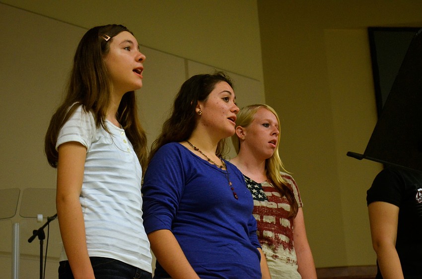 Alison Roland, Brittanie Smith and Ann Maree Grainger sing patriotic songs.