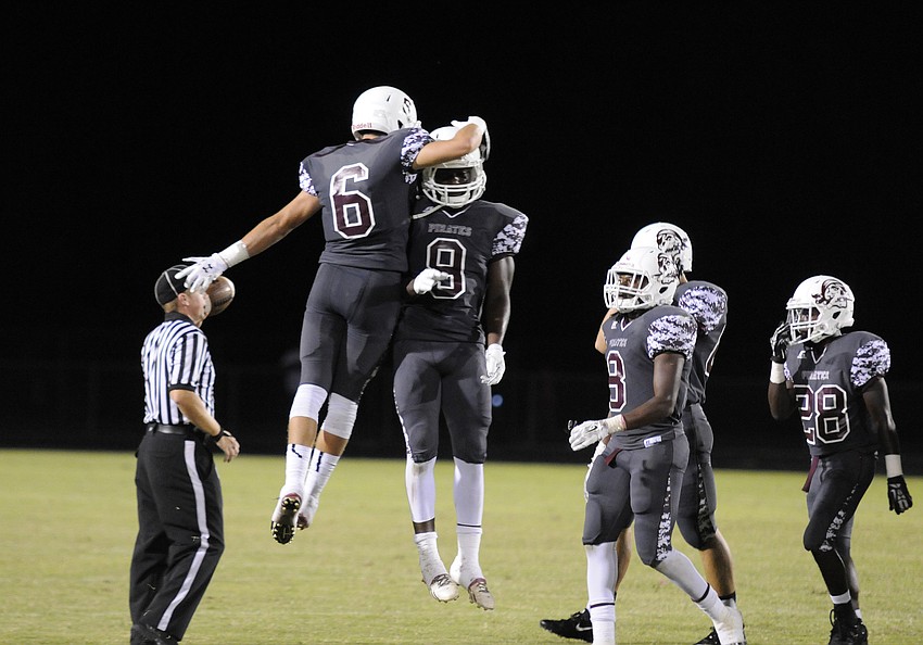Travis Williams congratulates JoJo Louis following his interception in the third quarter.