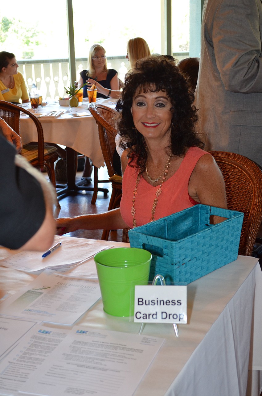 Victoria Jacobson of the Longboat Key Chamber of Commerce welcomes guest to the luncheon.