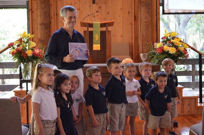 Author of Howard B. Wigglebottom, Howard Binkow poses with students from Out of Door Academy students.