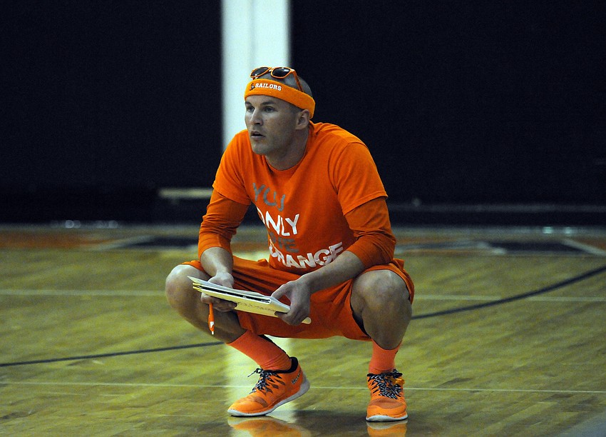 Sarasota head coach Chad Sutton watches his team rally back from a two-set deficit to defeat rival Riverview during the schoolâ€™s Orange Night Sept. 29.