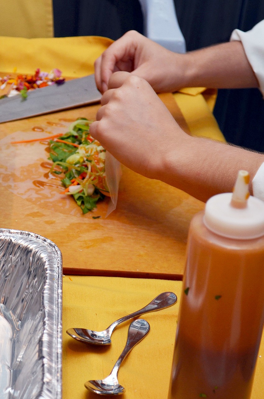 Students prepared and served vegetable spring rolls with ginger sauce.
