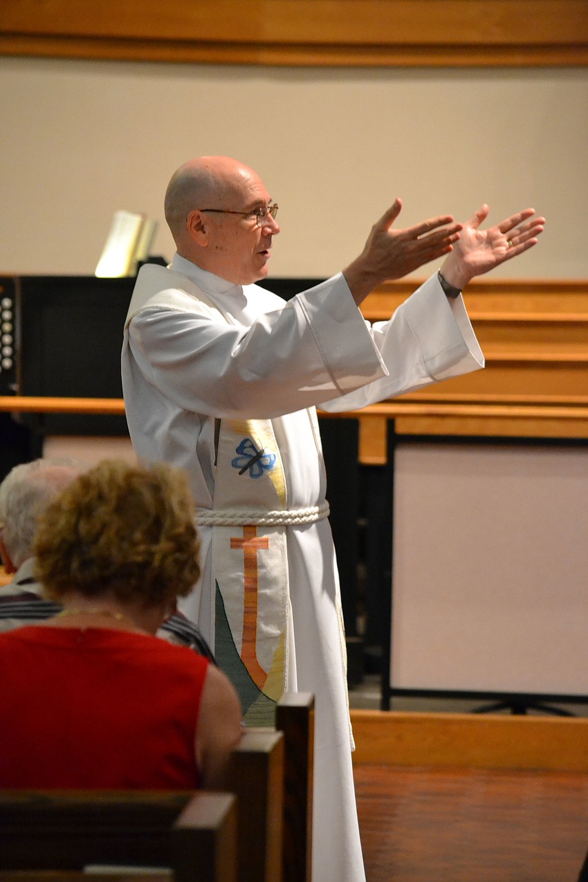 The Rev. John C. N. Hall leads the St. Boniface pet blessing service Saturday morning.
