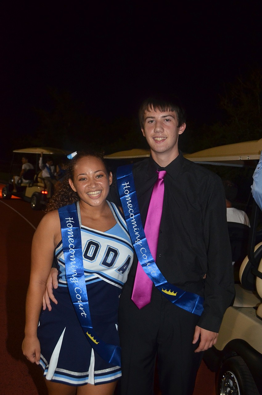 Junior princess and cheerleader Sierra Dickerson rushes to prince Dylan Goesâ€™ side for a photo opp.