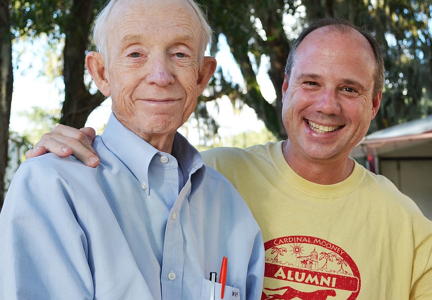 Father and son Webb and Patrick Foster wait to be served at the fish fry.