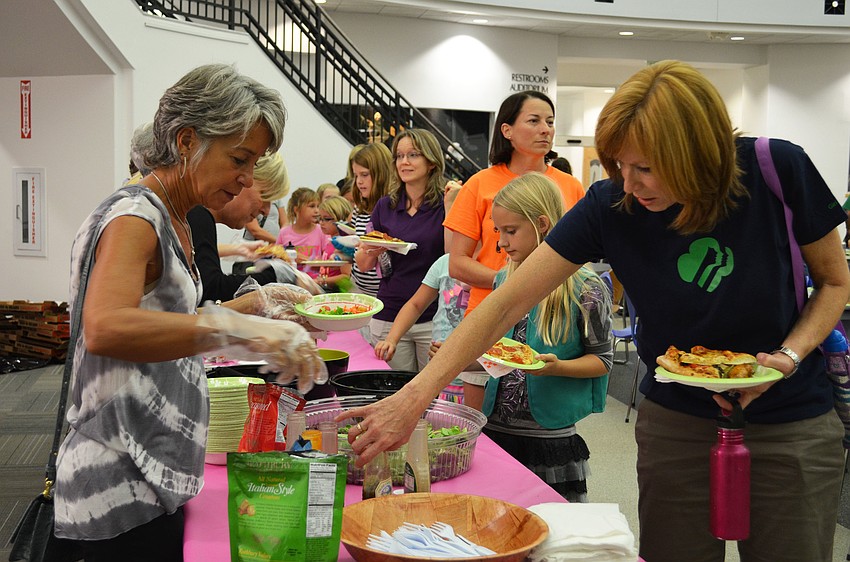 Friends of the Selby Library helped serve girl scouts and parents in attendance for the Scout About the Library event Friday evening.
