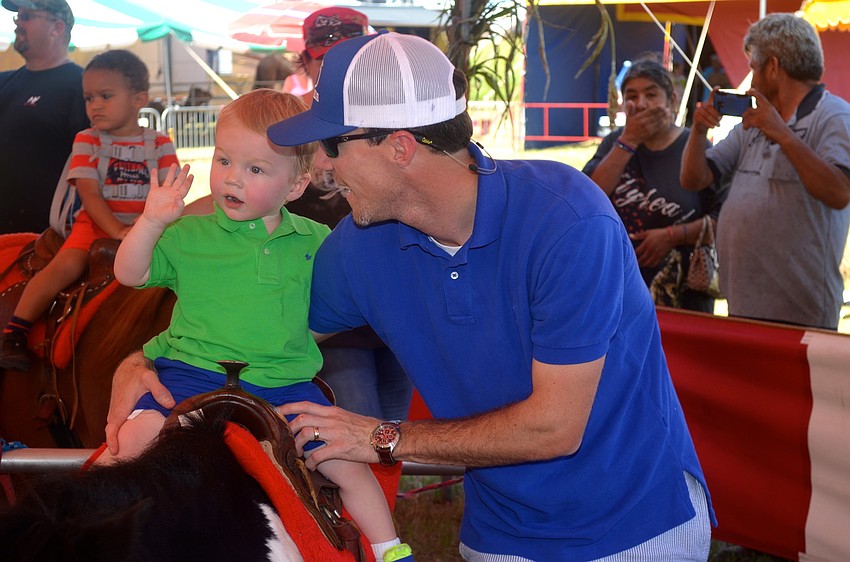 Cullen Fells rides a pony beside his father, Andrew.